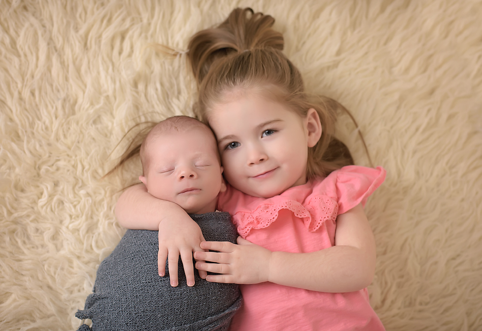Newborn baby boy and big sister