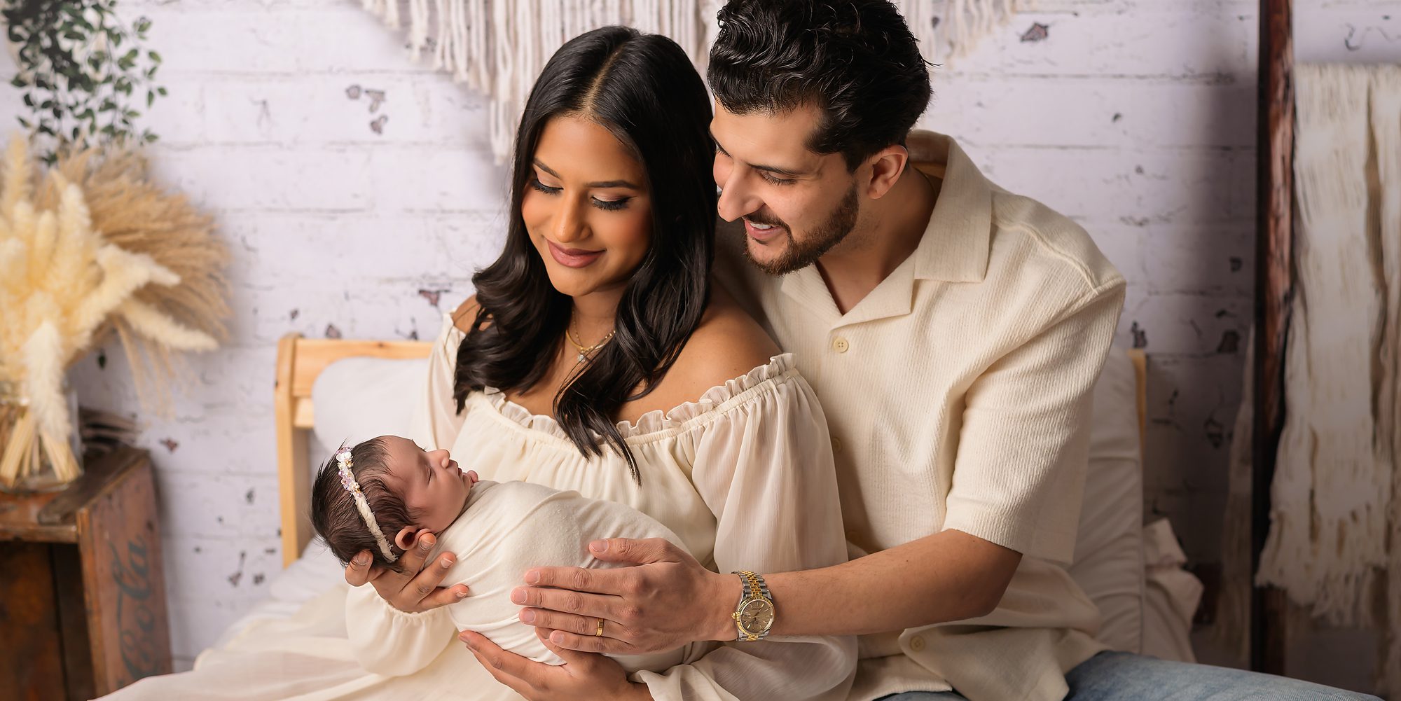 A mother and father with their newborn baby lifestyle photo shoot in Hamilton